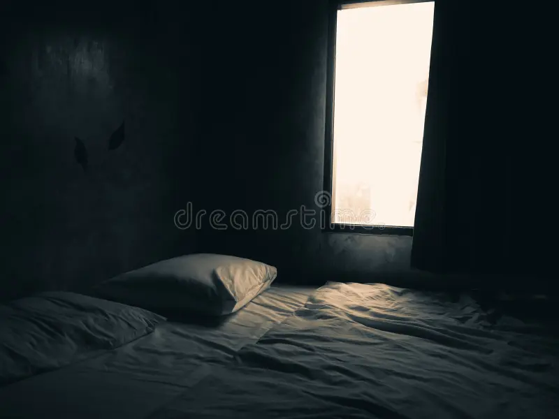 Dull and outdated bedroom before renovation with poor lighting and old furniture